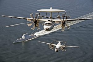 161017-N-UZ648-029 CHESAPEAKE BAY, Md. (Oct. 17, 2016) An E-2D Hawkeye and a C-2A Greyhound assigned to Air Test and Evaluation Squadron (VX) 20 fly over USS Zumwalt (DDG 1000) as the ship travels to its new home port of San Diego, California. Zumwalt was commissioned in Baltimore, Maryland, Oct. 15 and is the first in a three-ship class of the Navy's newest, most technologically advanced multi-mission guided-missile destroyers. (U.S. Navy photo by Erik Hildebrandt/Released)