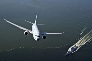 161017-N-UZ648-054 CHESAPEAKE BAY, Md. (Oct. 17, 2016) A P-8A Poseidon assigned to Air Test and Evaluation Squadron (VX) 20 flies over USS Zumwalt (DDG 1000) as the ship travels to its new home port of San Diego, California. Zumwalt was commissioned in Baltimore, Maryland, Oct. 15 and is the first in a three-ship class of the Navy's newest, most technologically advanced multi-mission guided-missile destroyers. (U.S. Navy photo by Erik Hildebrandt/Released)