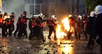 Info Shqip: Bulevardi kthehet në fushëbetejë, një polic përfshihet në flakë pas hedhjes së molotovit